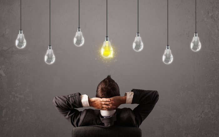 Businness guy in front of idea light bulbs concept