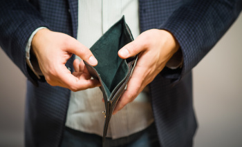Bankruptcy – Business Person holding an empty wallet