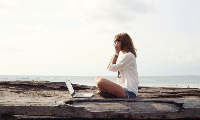 Outdoor portrait of young writer/blogger/freelancer/student with laptop