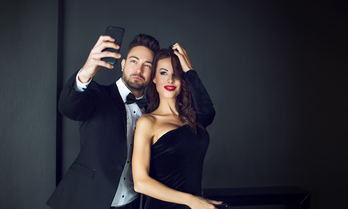 Fashionable rich celebrity couple taking selfie
