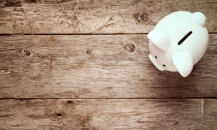 Piggy bank on the old wooden background.